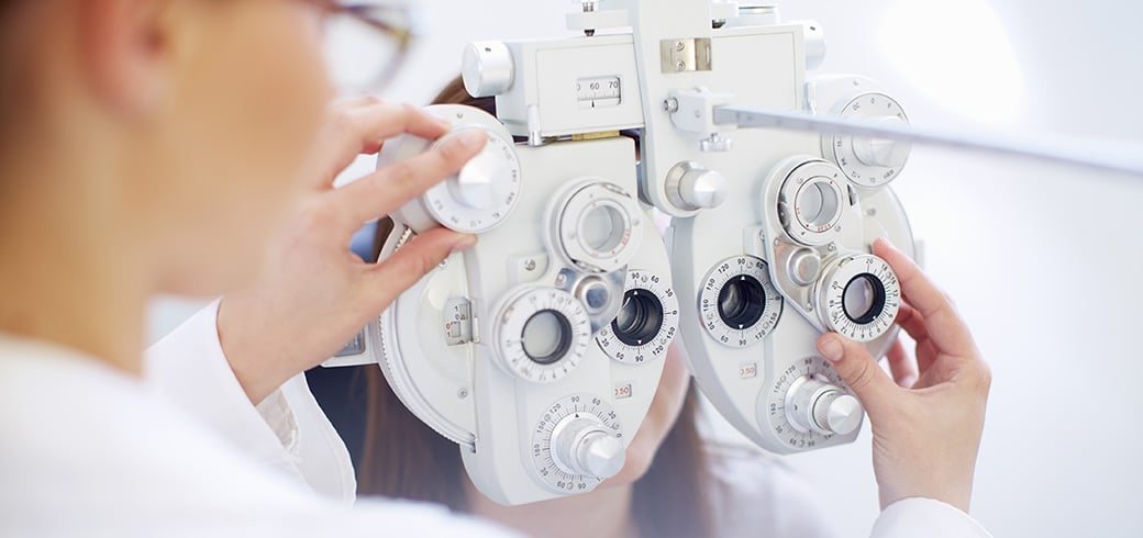 An Optician working with eye test equipment.